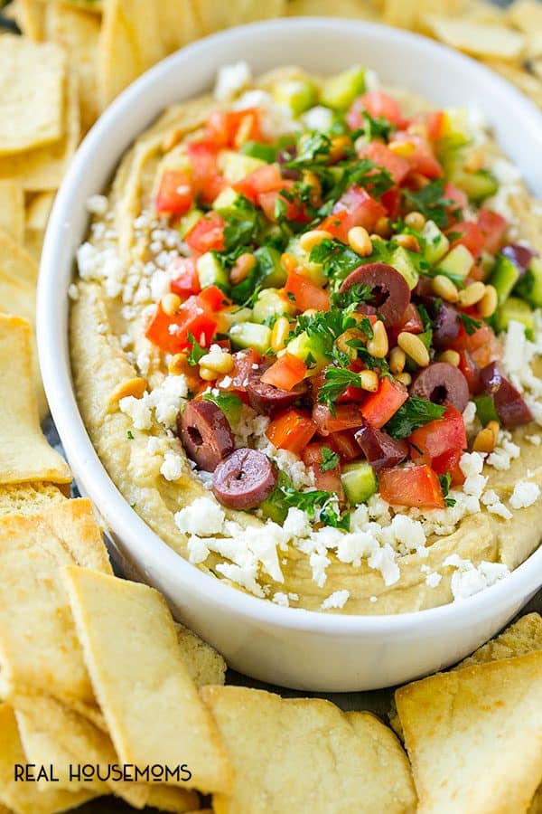 This easy Greek Layered Dip is the perfect 10-minute party appetizer that's a total crowd pleaser. Serve this dip with pita chips or fresh veggie and watch it disappear!