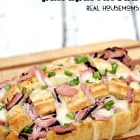 HAM AND SWISS PULL APART BREAD is made with cheesy, gooey Swiss cheese, Virginia ham, and takes less than 30 minutes to make. Perfect for noshing in a hurry!