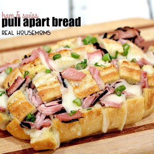 HAM AND SWISS PULL APART BREAD is made with cheesy, gooey Swiss cheese, Virginia ham, and takes less than 30 minutes to make. Perfect for noshing in a hurry!
