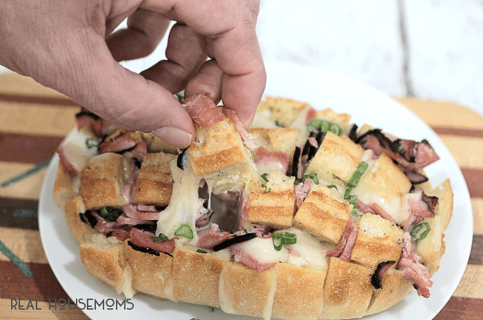 Looking to nosh is a hurry? This pull apart bread is made with cheesy, gooey swiss, Virginia ham, and takes less than 30 minutes to make!