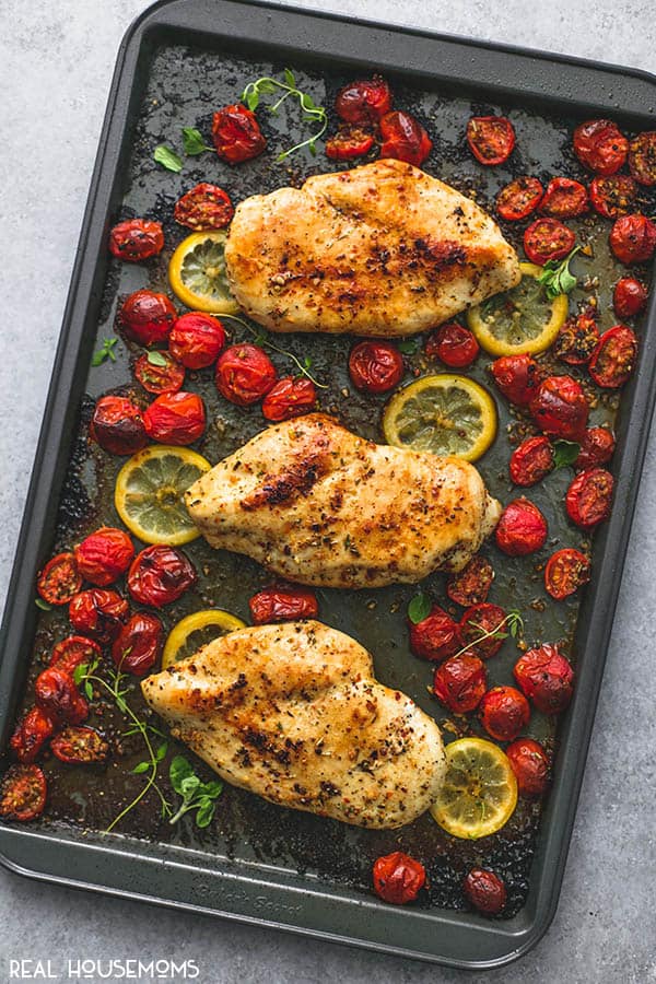 Overhead shot os One Pan Baked Italian Chicken & Tomatoes finished cooking on a sheet pan