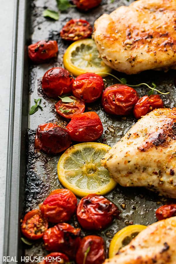 Close up of these roasted tomatoes and lemons in One Pan Baked Italian Chicken & Tomatoes recipe