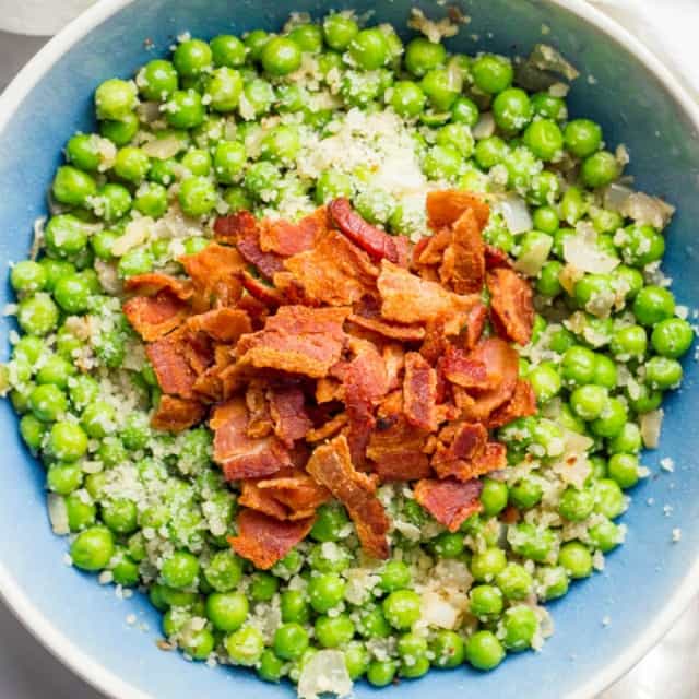 Peas with Bacon, Shallots, and Parmesan cheese is a quick, easy and super flavorful way to dress up a bag of frozen peas!