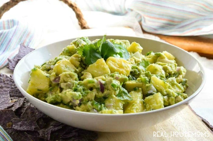 PINEAPPLE GUACAMOLE is a flavor combo that seems strange but works so well! Creamy avocado with sweet and tangy pineapple chunks makes the perfect summertime snack!
