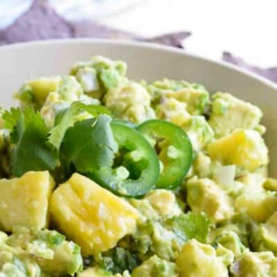 PINEAPPLE GUACAMOLE is a flavor combo that seems strange but works so well! Creamy avocado with sweet and tangy pineapple chunks makes the perfect summertime snack!