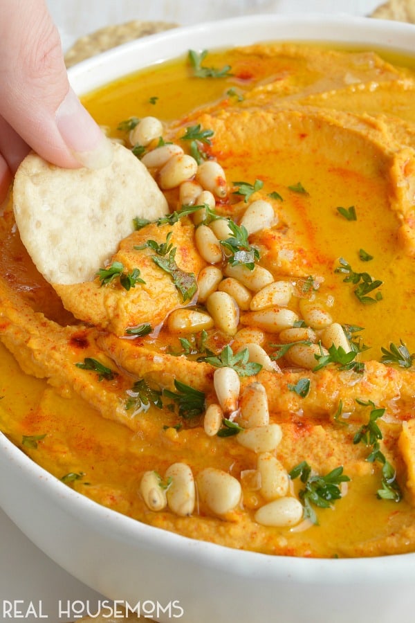 Pumpkin Hummus needs to be on your holiday menu! This hummus recipe is super creamy, full of flavor and great for feeding a hungry crowd!