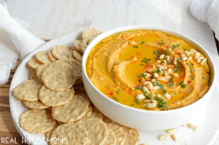 Pumpkin Hummus needs to be on your holiday menu! This hummus recipe is super creamy, full of flavor and great for feeding a hungry crowd!