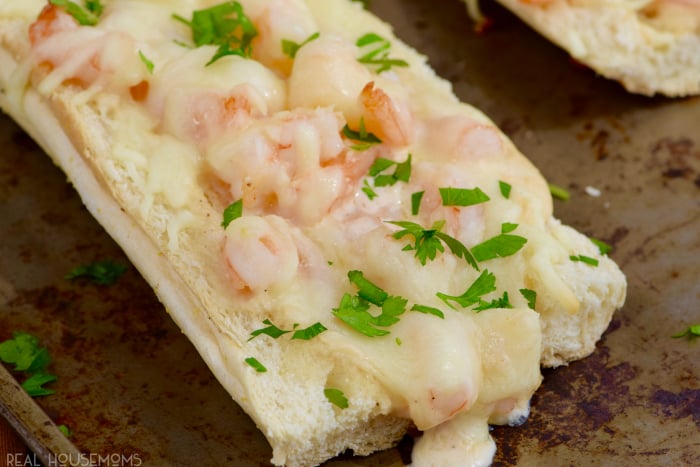 This Shrimp Alfredo French Bread Pizza is a seriously easy SERIOUSLY delicious dinner that doubles as a great appetizer!