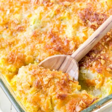Squash casserole in a baking dish with a spoon
